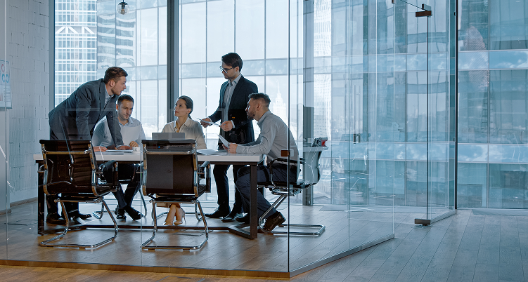 Team discussing opportunities in a glass meeting room